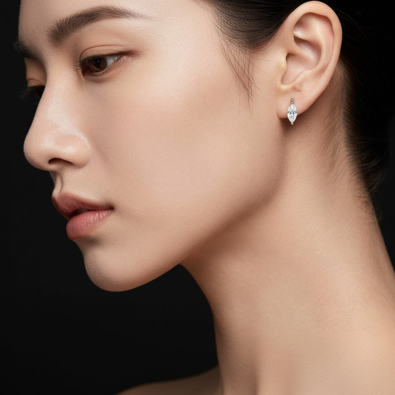 Model wearing marquise solitaire huggie earrings