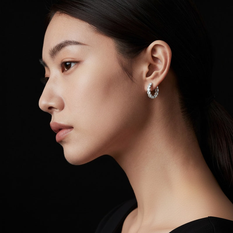 Model wearing round inside out hoop earrings