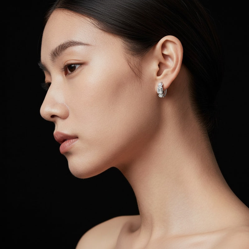 Model wearing emerald three stone earrings