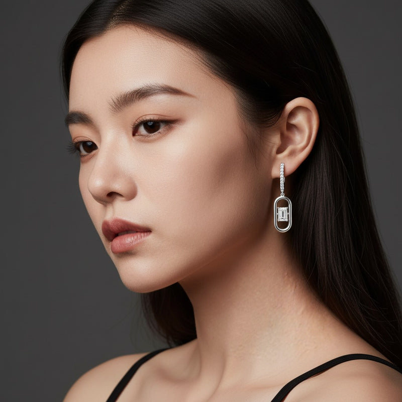 Model wearing emerald paperclip dangle earrings