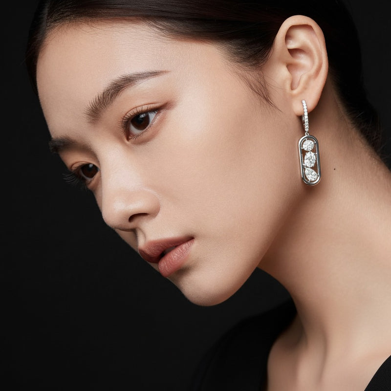 Model wearing mixed paperclip dangle earrings