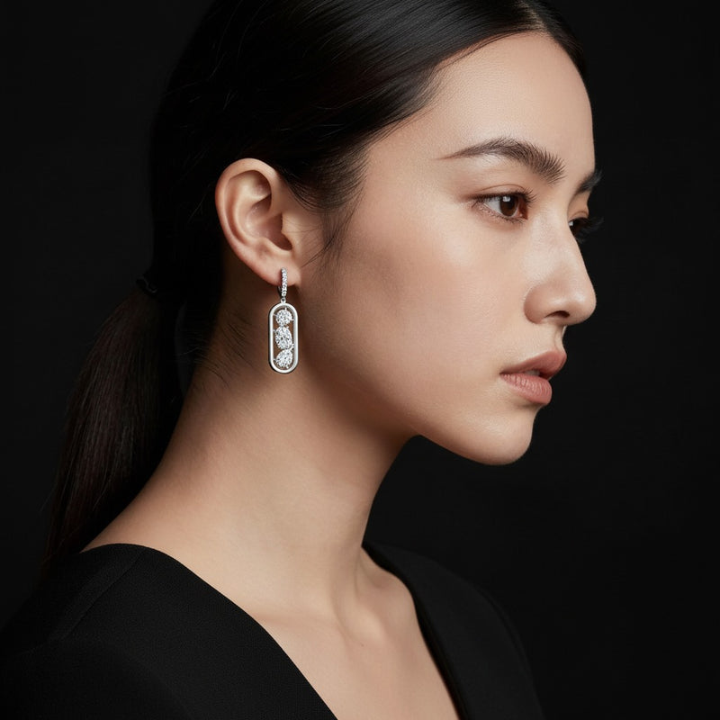 Model wearing mixed paperclip dangle earrings