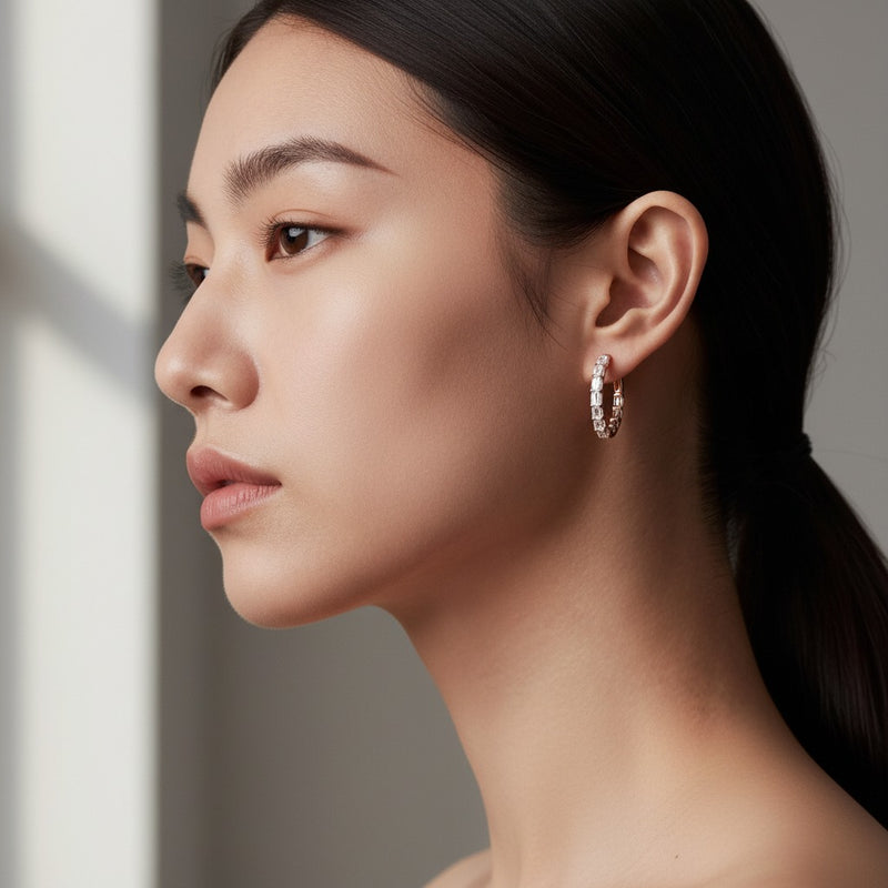Model wearing emerald inside out hoop earrings