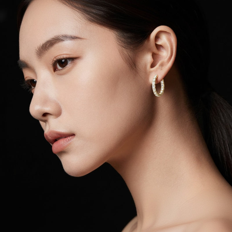 Model wearing oval inside out hoop earrings