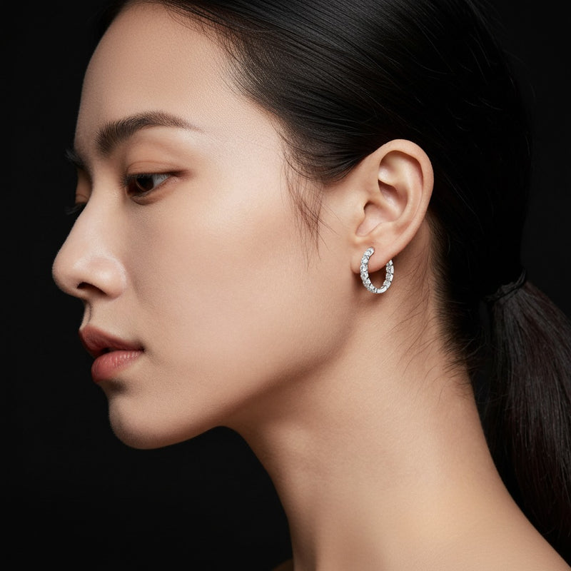 Model wearing round inside out hoop earrings