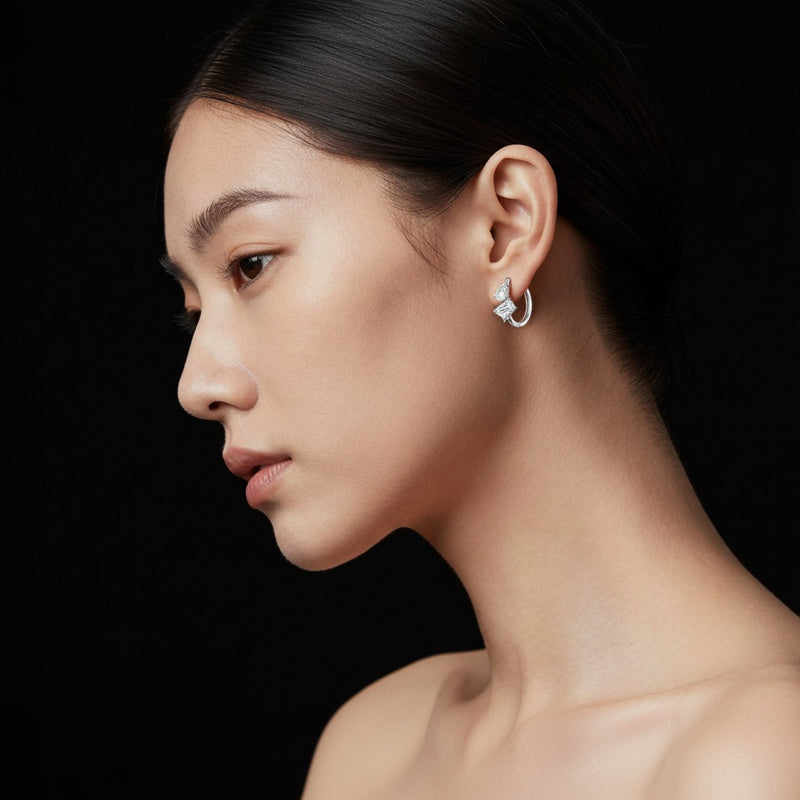 Model wearing emerald toi et moi huggie earrings