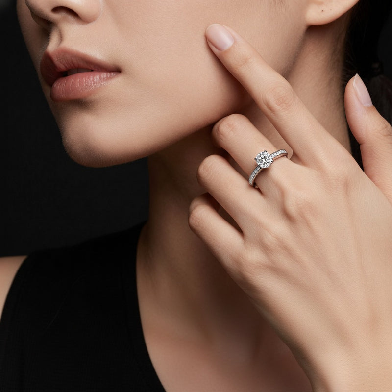 Model wearing pear cross shank accented engagement ring
