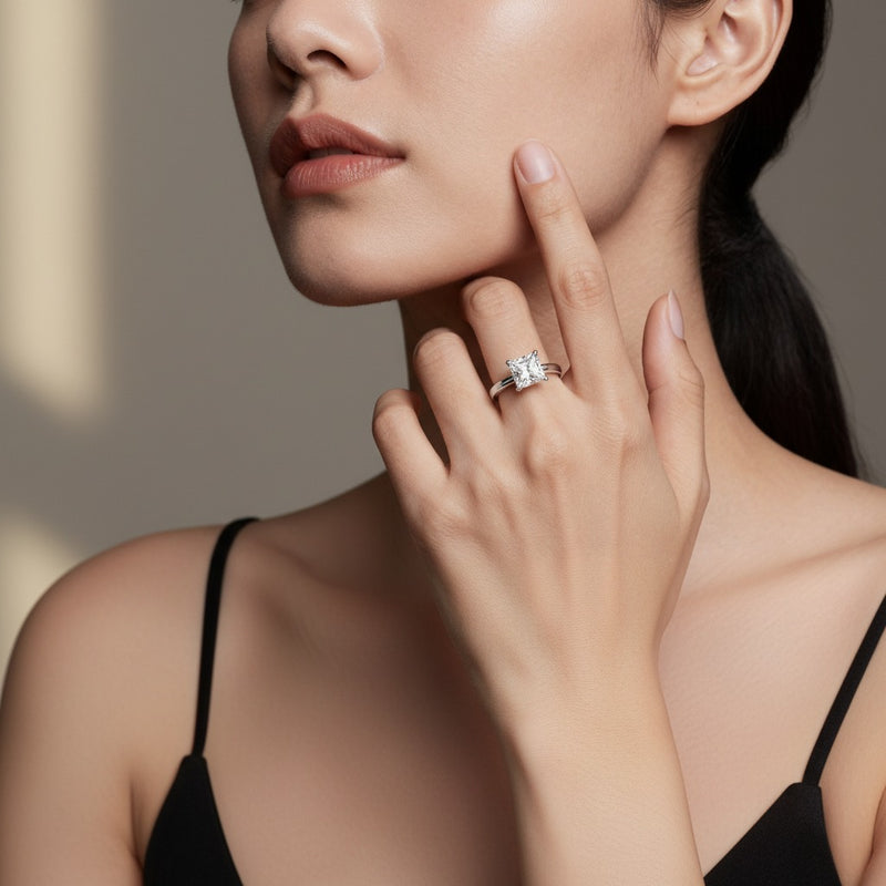 Model wearing princess plain cathedral trellis shank solitaire engagement ring