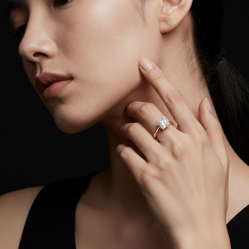 Model wearing princess plain cathedral trellis shank solitaire engagement ring