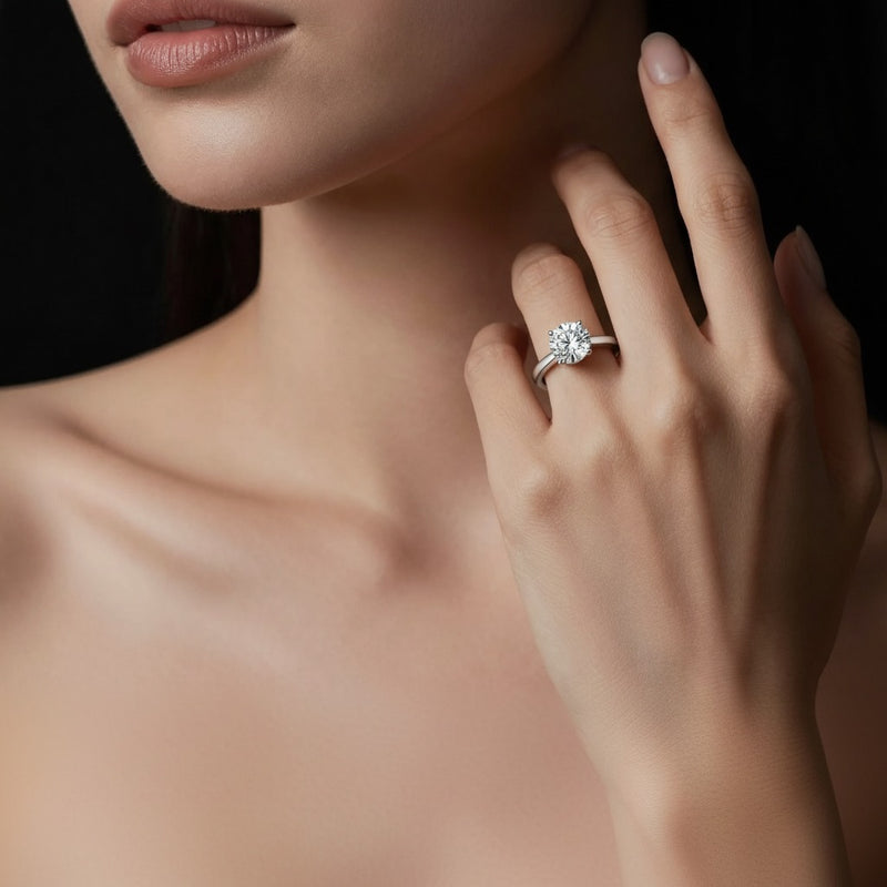 Model wearing round plain cathedral trellis shank solitaire engagement ring