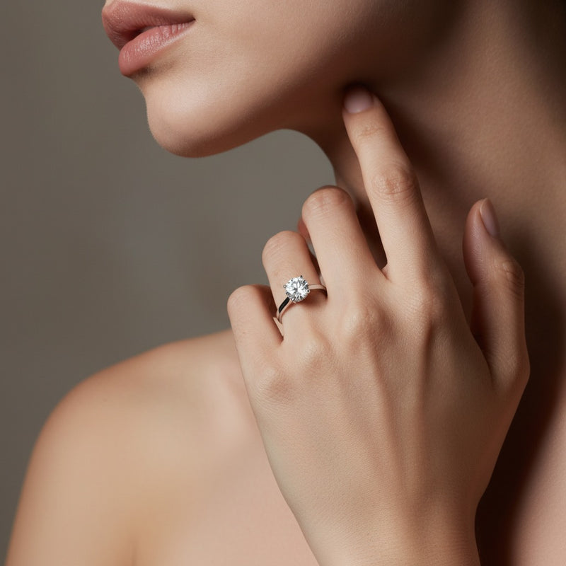 Model wearing round plain cathedral trellis shank solitaire engagement ring