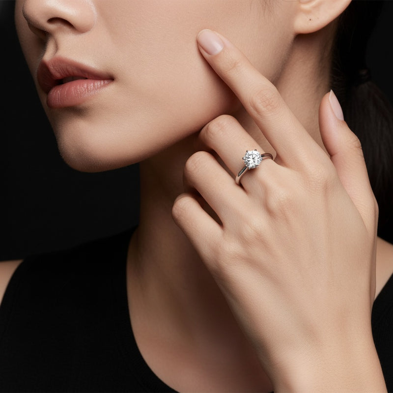 Model wearing round hidden halo plain shank engagement ring