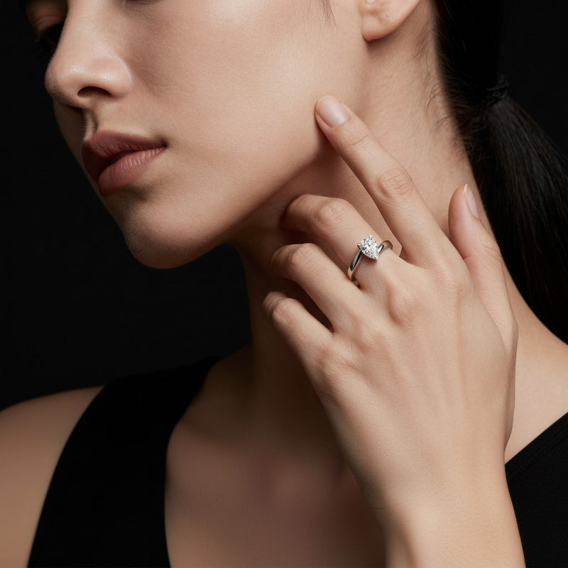 Model wearing pear bypass shank engagement ring