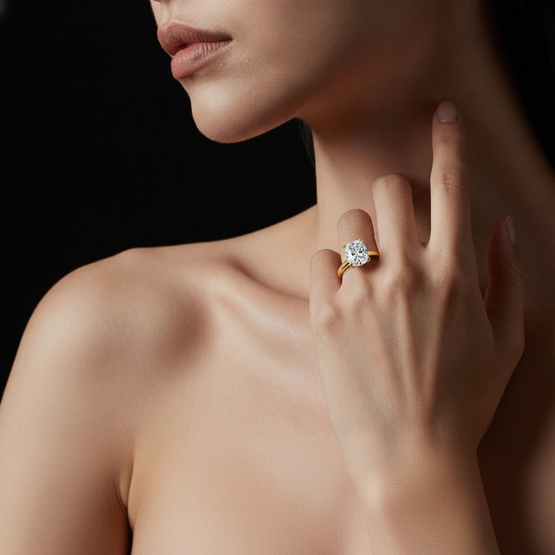 Model wearing cushion hidden halo cathedral shank engagement ring