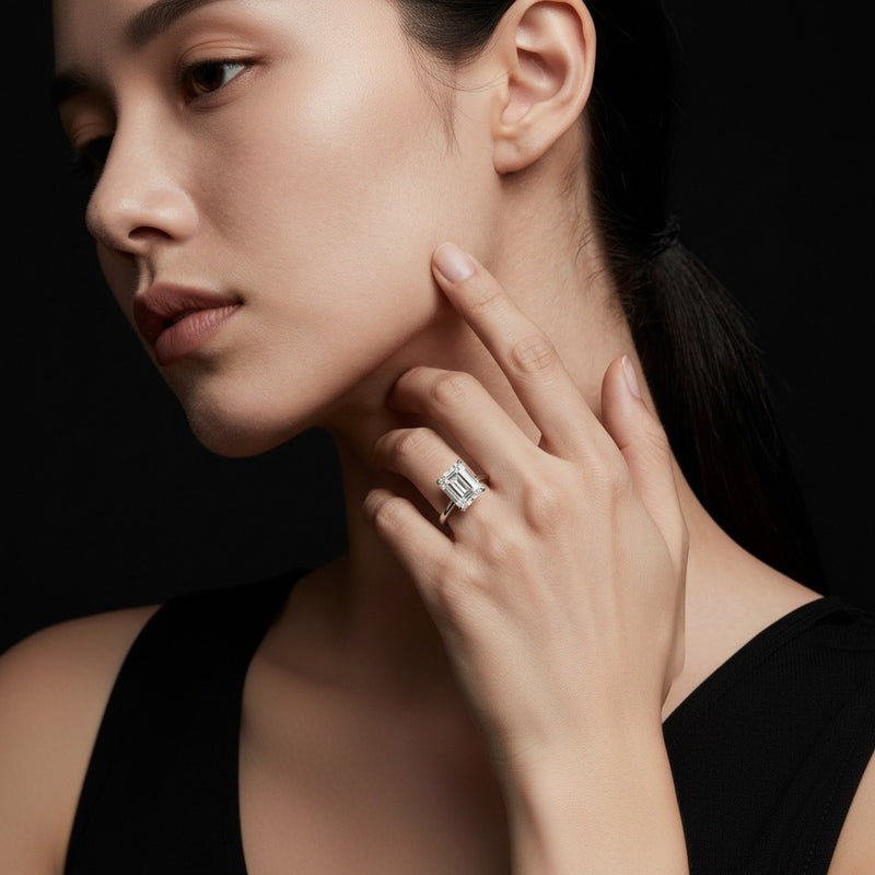 Model wearing emerald hidden halo cathedral shank engagement ring