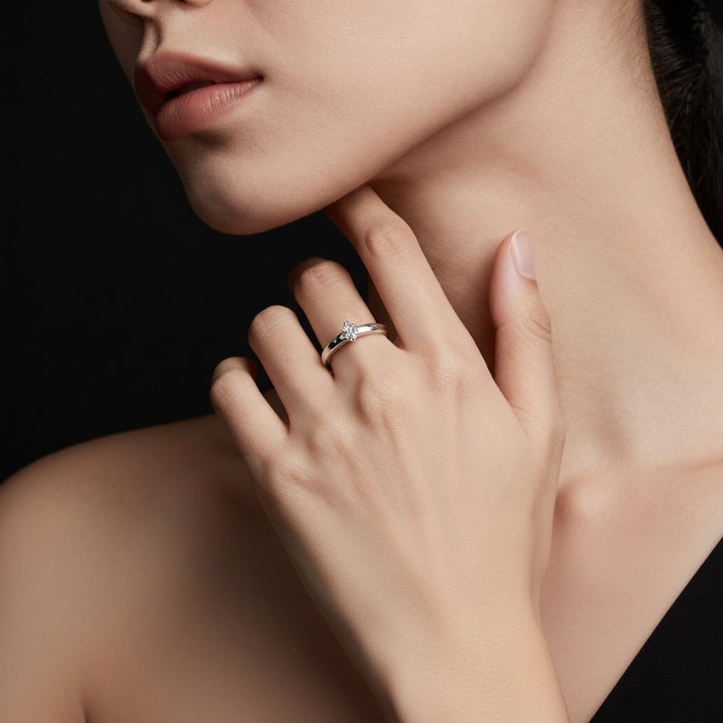 Model wearing oval hidden halo cathedral shank engagement ring