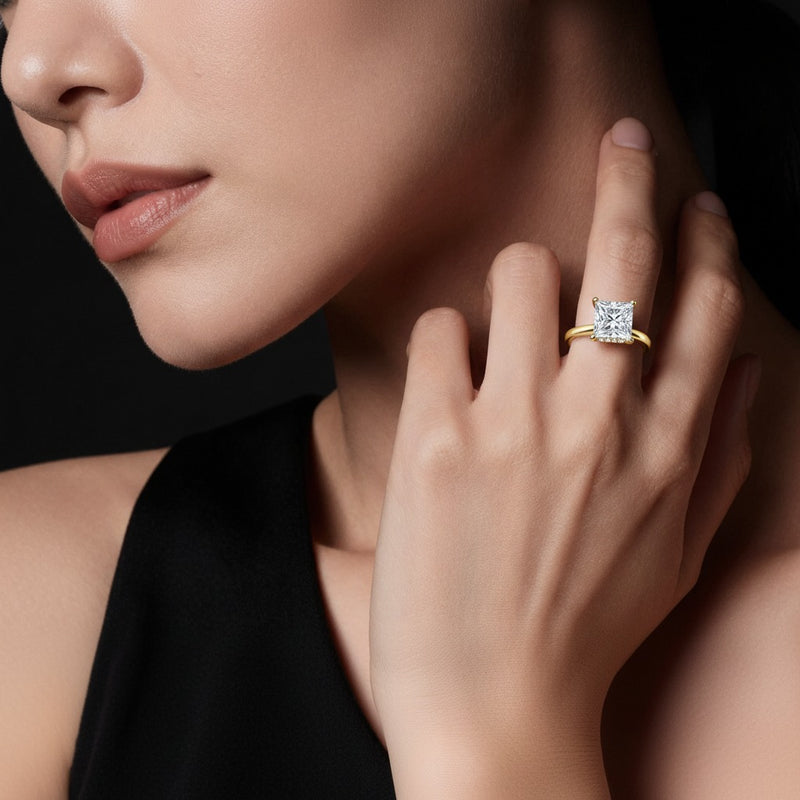 Model wearing princess hidden halo cathedral shank engagement ring