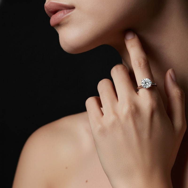 Model wearing round hidden halo cathedral shank engagement ring