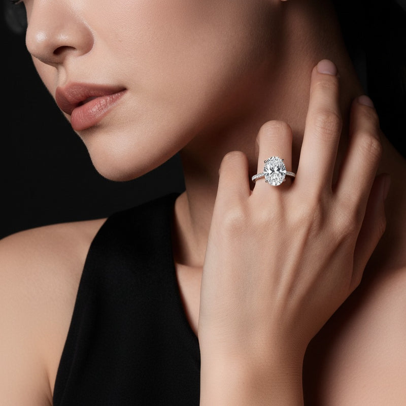 Model wearing oval hidden halo accented engagement ring