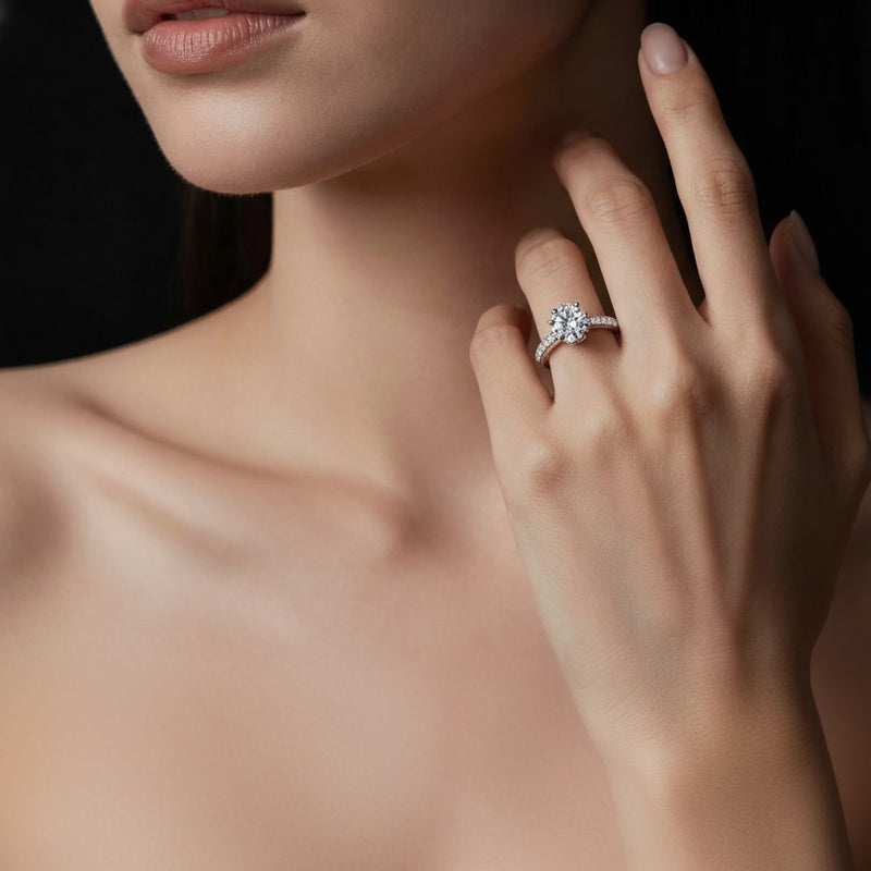 Model wearing pear hidden halo accented engagement ring