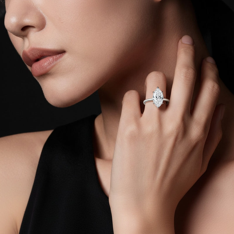 Model wearing marquise knife edge shank solitaire engagement ring