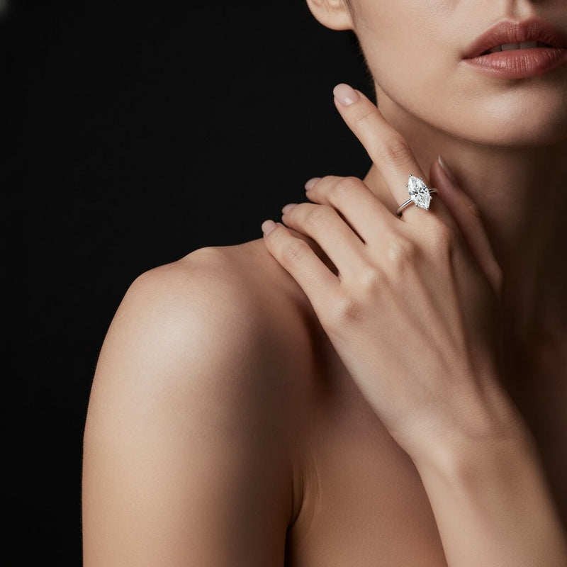 Model wearing marquise knife edge shank solitaire engagement ring