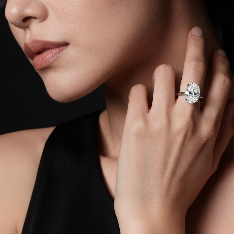 Model wearing oval knife edge shank solitaire engagement ring