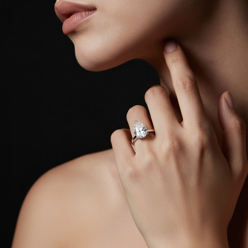 Model wearing pear knife edge shank solitaire engagement ring