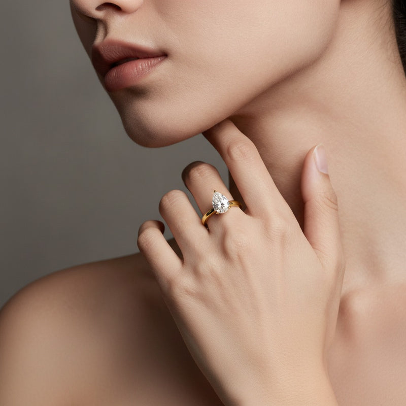 Model wearing pear knife edge shank solitaire engagement ring