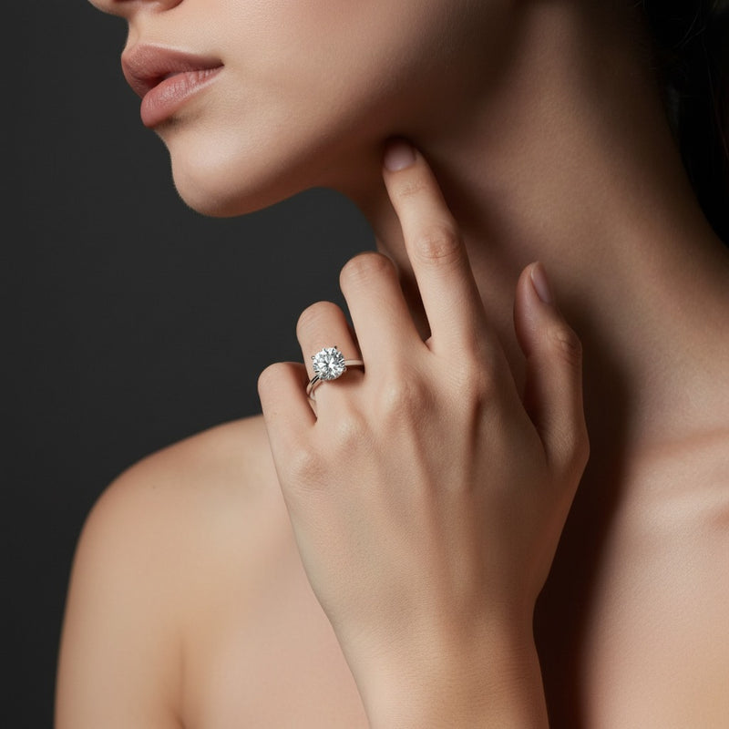 Model wearing round knife edge shank solitaire engagement ring
