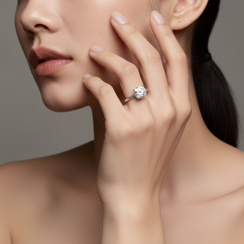 Model wearing round knife edge shank solitaire engagement ring