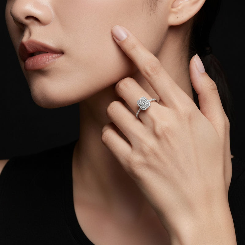 Model wearing emerald halo accented engagement ring