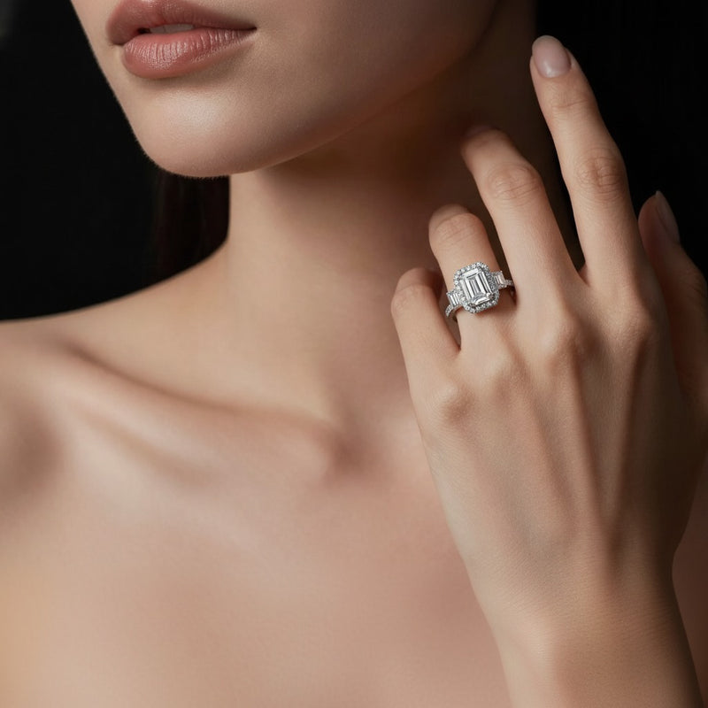 Model wearing emerald three stone accented engagement ring