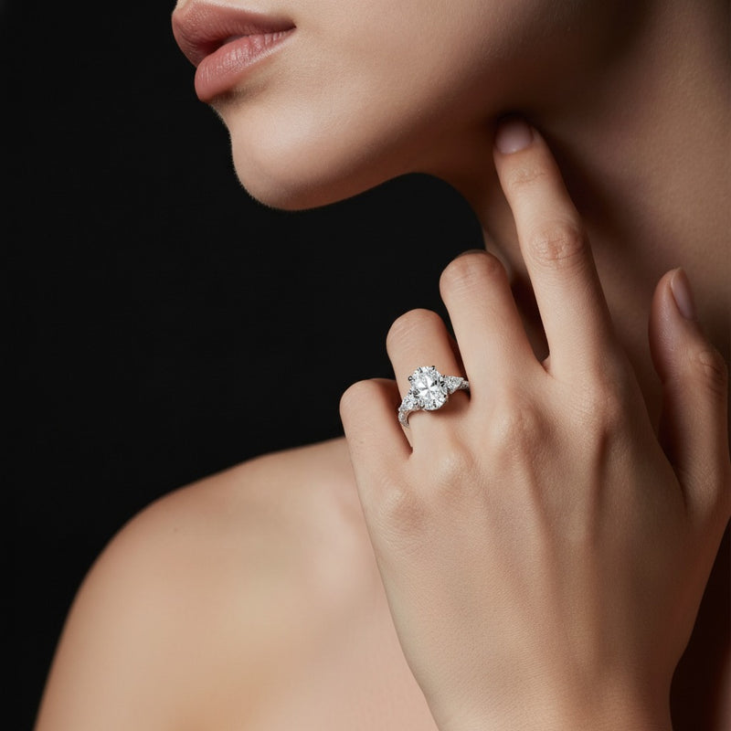 Model wearing oval three stone accented engagement ring