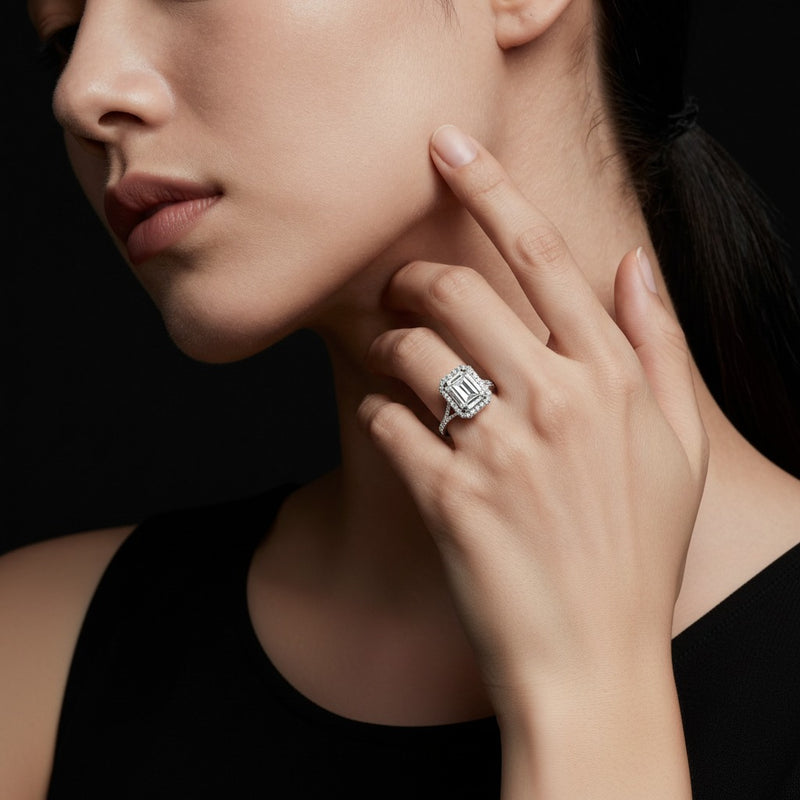 Model wearing emerald halo accented engagement ring