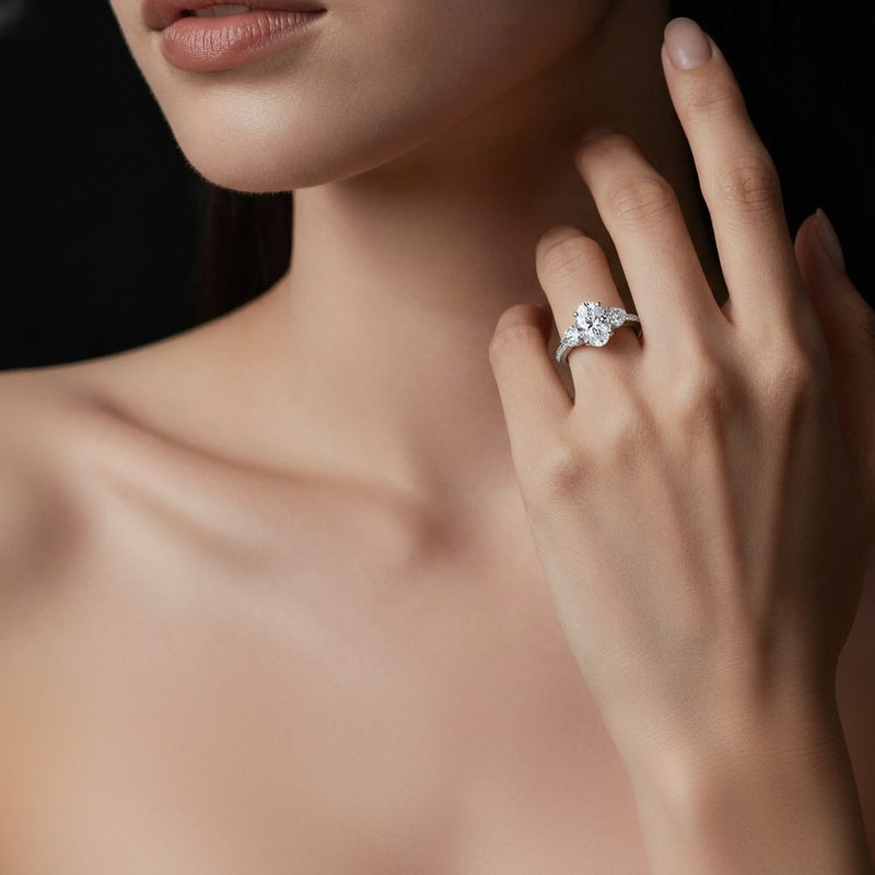 Model wearing oval three stone accented engagement ring
