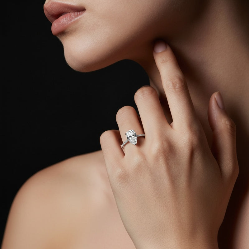 Model wearing pear three row micro pave engagement ring
