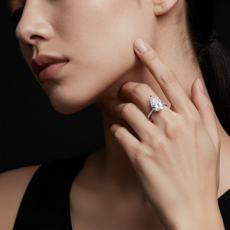 Model wearing pear tulip motif accented engagement ring