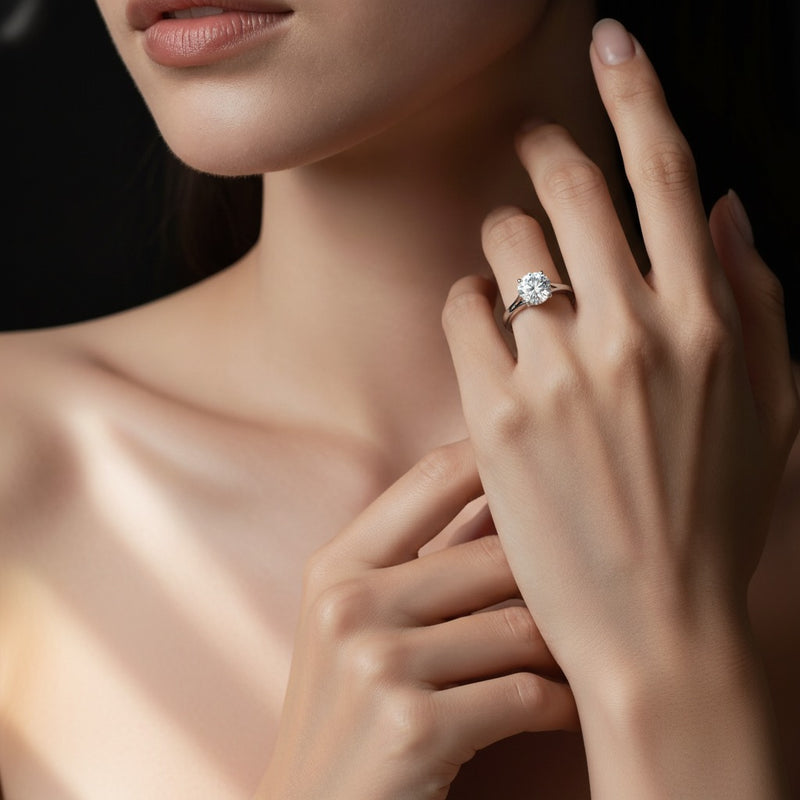 Model wearing round split shank solitaire engagement ring