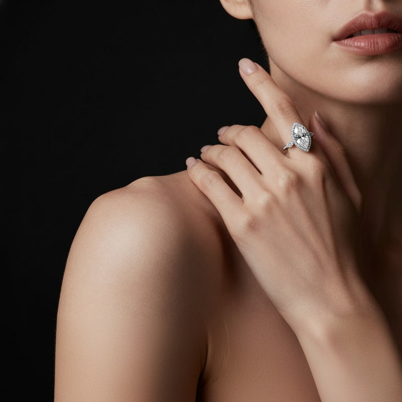 Model wearing marquise three stone halo enagement ring