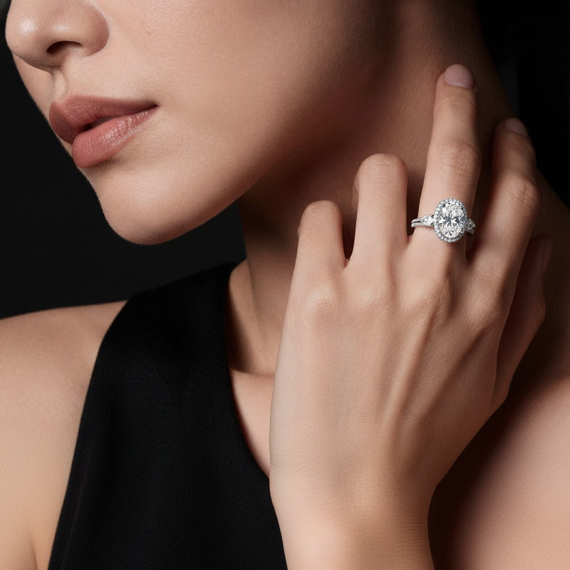Model wearing oval three stone halo enagement ring