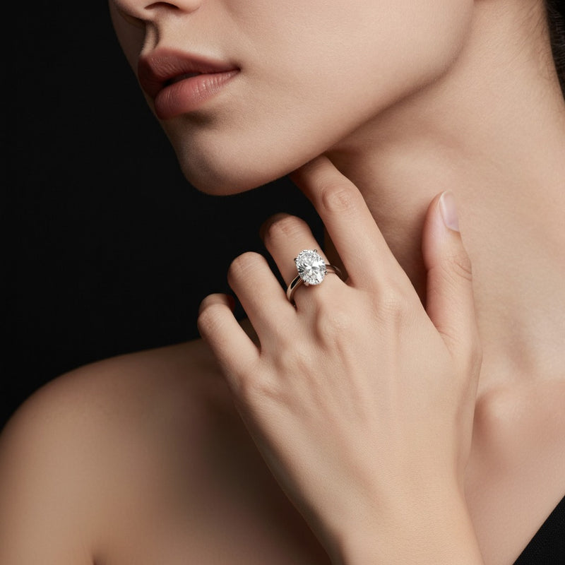 Model wearing oval classic shank solitaire engagement ring