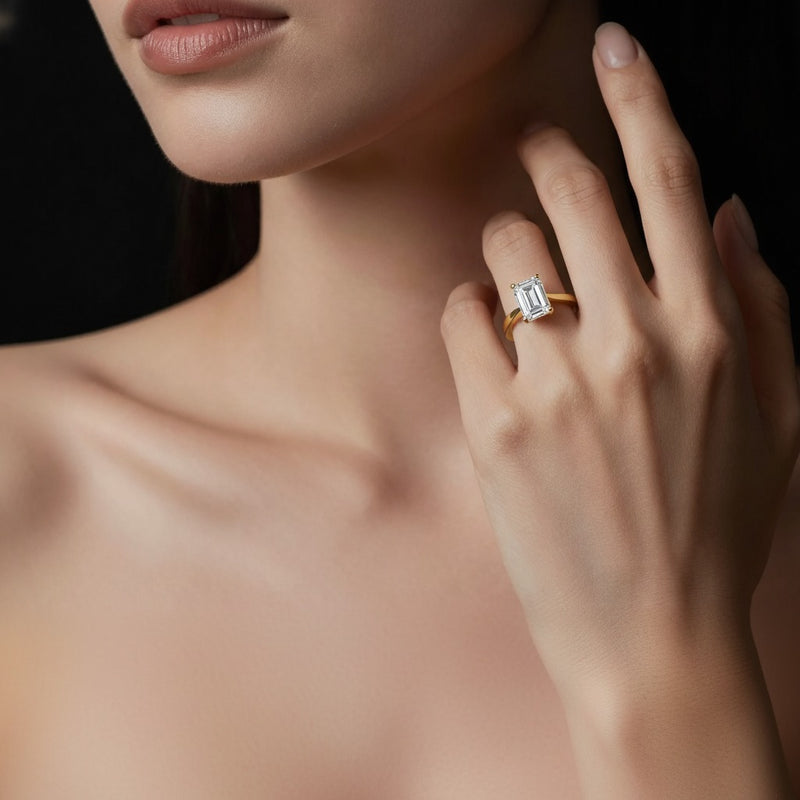 Model wearing emerald two tone cathedral shank engagement ring