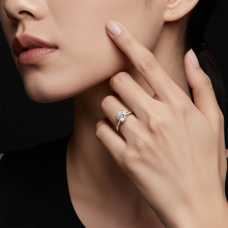 Model wearing round two tone cathedral shank engagement ring