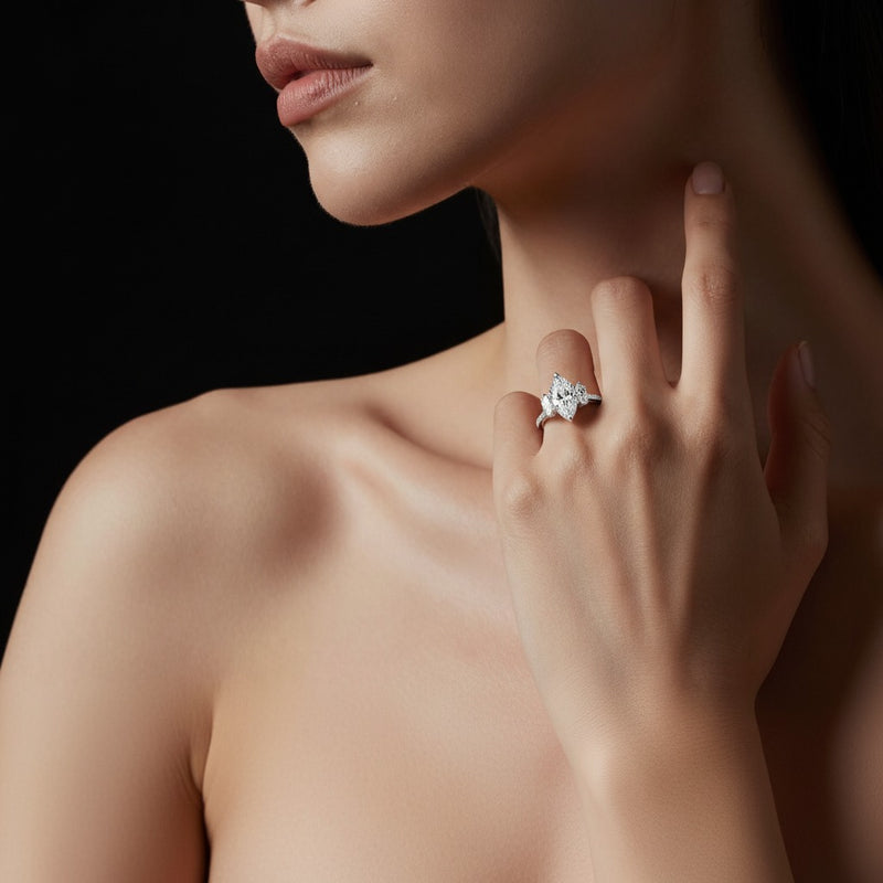 Model wearing marquise three stone accented engagement ring