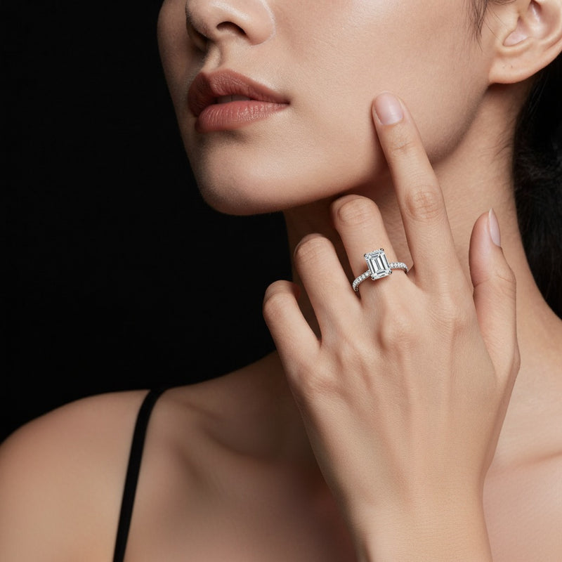 Model wearing emerald hidden halo accented ring