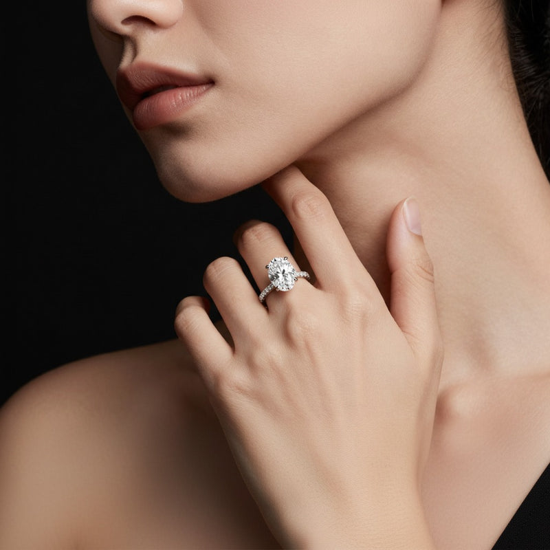 Model wearing oval hidden halo accented ring