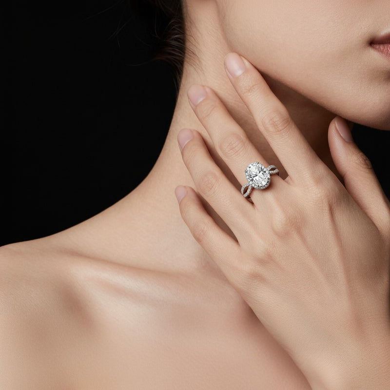 Model wearing oval split shank halo accented engagement ring