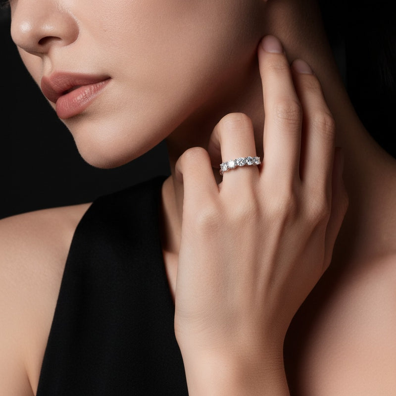 Model wearing round five stone band ring