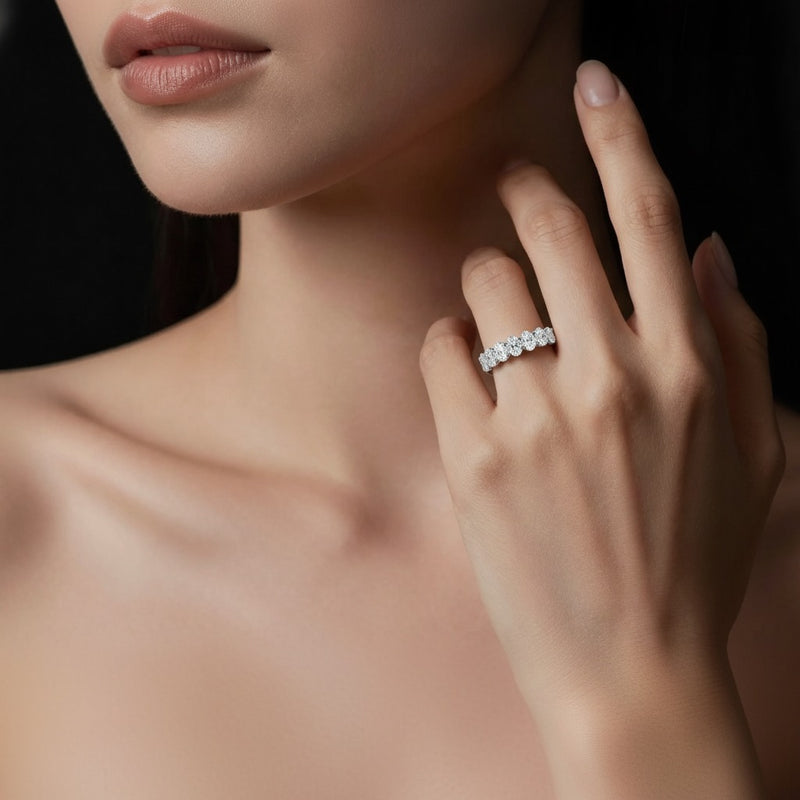 Model wearing oval seven stone band ring